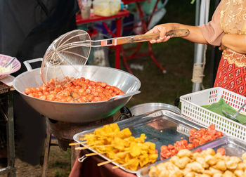 Midsection of man preparing food in kitchen
