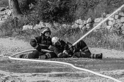 Rescue workers holding pipe