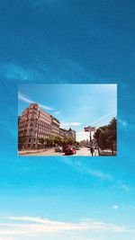 Buildings by swimming pool against blue sky
