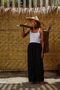 Rear view of woman standing against brick wall