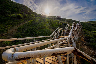 Staircase on mountain against sky