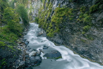 River flowing through rocks in forest