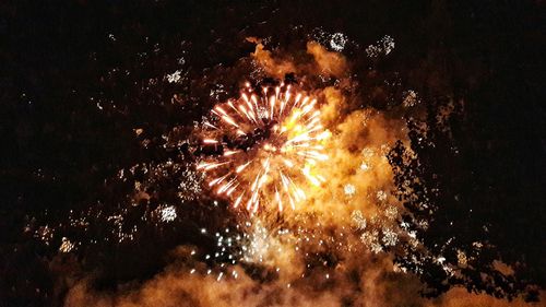 Low angle view of firework display at night