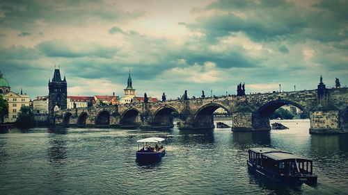 Boats in river with buildings in background