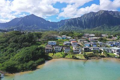 Scenic view of buildings and mountains against sky