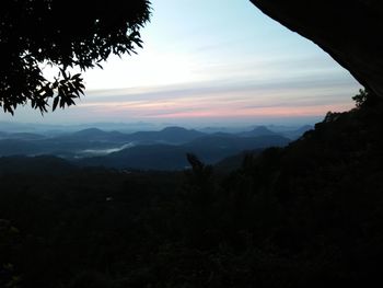 Scenic view of silhouette mountains against sky at sunset