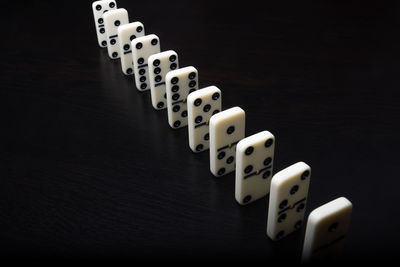 High angle view of piano keys on table against black background