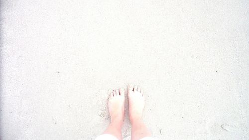Low section of woman standing on tiled floor