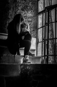 Woman sitting on window