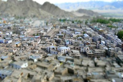 Tilt-shift image of cityscape against sky