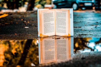 Close-up of text on wet street