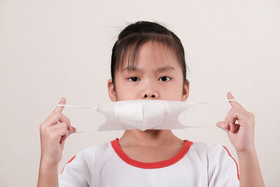 Portrait of boy holding white background