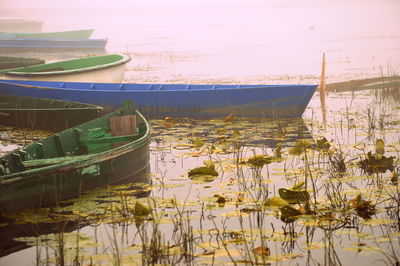 Boats moored in lake against sky