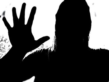 Silhouette of man against white background