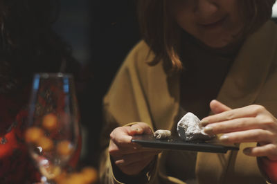 Midsection of woman holding mineral