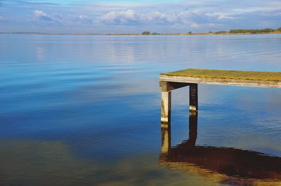Pier on lake against sky