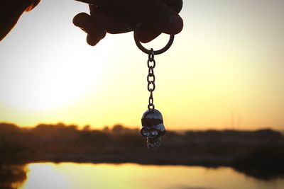 Close-up of silhouette chain against sky at sunset