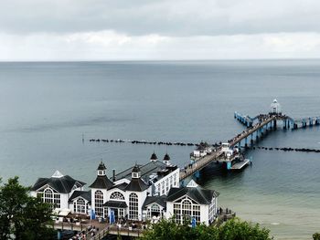 High angle view of buildings by sea against sky