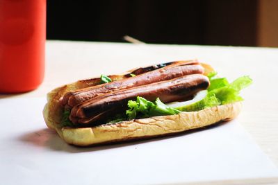 Photo of sausage on bread with vegetables as a meal