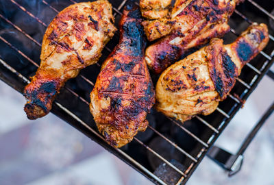 High angle view of meat on barbecue grill
