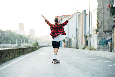 Rear view of person skateboarding on skateboard