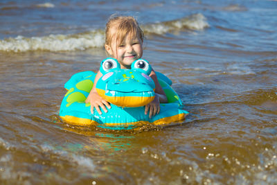 Portrait of boy swimming in sea