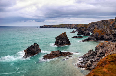 Rocks in sea against sky