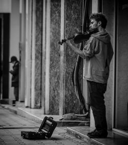 Homeless man playing violin at street