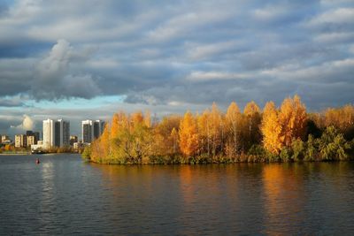 Scenic view of lake by trees against sky