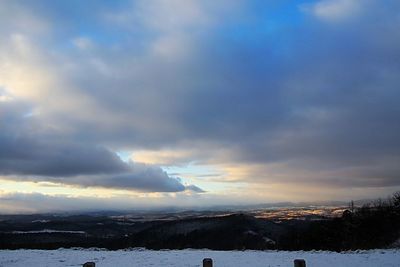 Scenic view of landscape against sky during winter