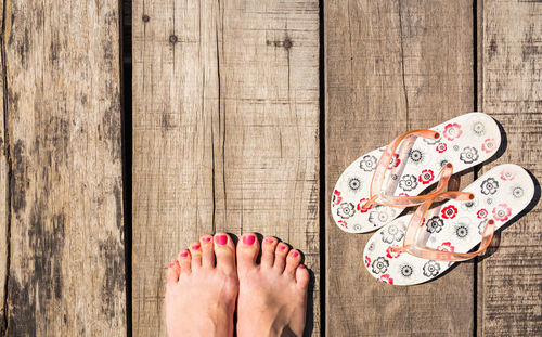 Low section of woman standing on hardwood floor