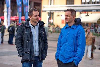 Men standing on street in city