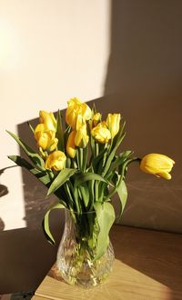 Close-up of yellow flower vase on table