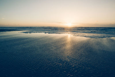 Scenic view of sea against clear sky during sunset