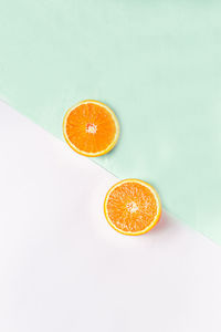 High angle view of orange slice against white background