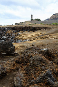 View of lighthouse on land against sky