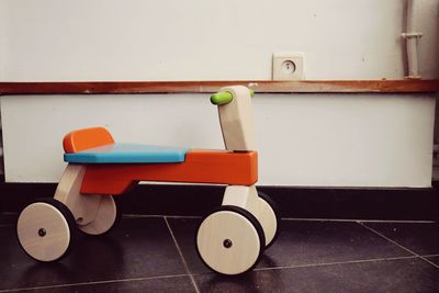 Close-up of empty seats on table against wall