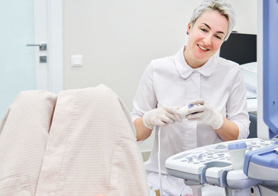 Gynecologist examining patient at hospital