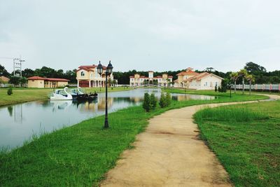 Houses by lake against sky