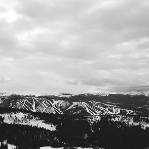 Scenic view of mountains against cloudy sky