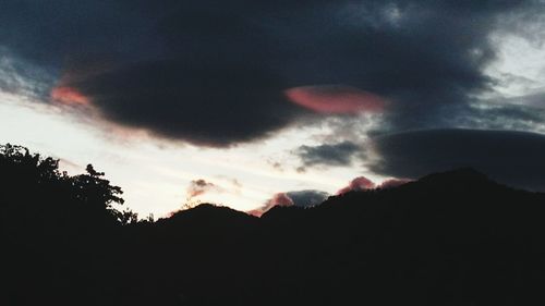 Scenic view of silhouette mountains against sky at sunset