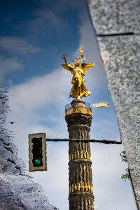 Low angle view of statue against sky