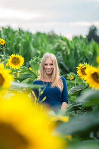 Portrait of smiling woman with sunflower