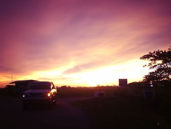 Cars on road at sunset