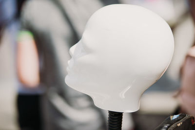 Close-up of white balloon holding balloons