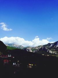 Scenic view of mountains against blue sky