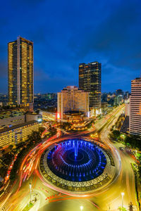 High angle view of illuminated city street and buildings at night