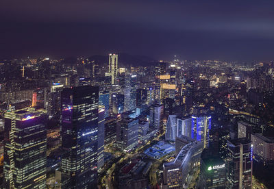 Illuminated cityscape against sky at night