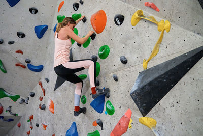 Woman training at bouldering gym. active recreation, sports exercises