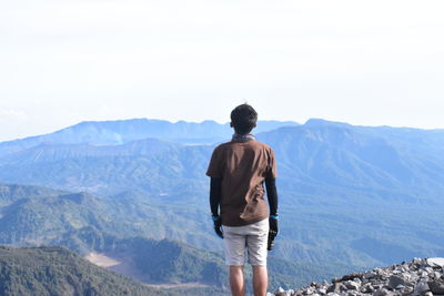 Rear view of man looking at mountains